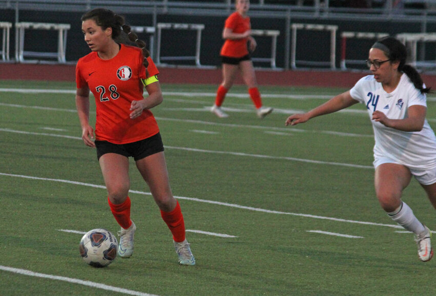 Kirksville junior Lucy Tiedemann advances the ball upfield in the Tigers' game against Moberly on March 27.&nbsp;