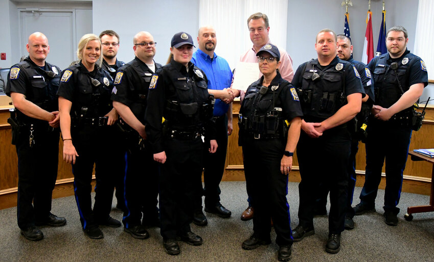 Members of the Kirksville Police Department and Deputy Chief Justin Jones are pictured with Mayor Zac Burden.