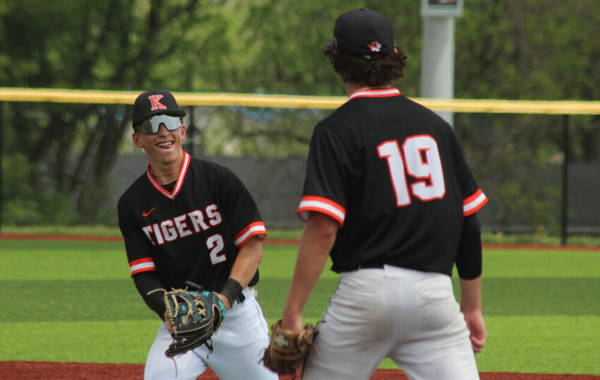 Kirksville senior Jalen Kent smiles at fellow senior Keaton Anderson after catching a popup to end the Tigers' win over Centralia in the district tournament on May 13.&nbsp;