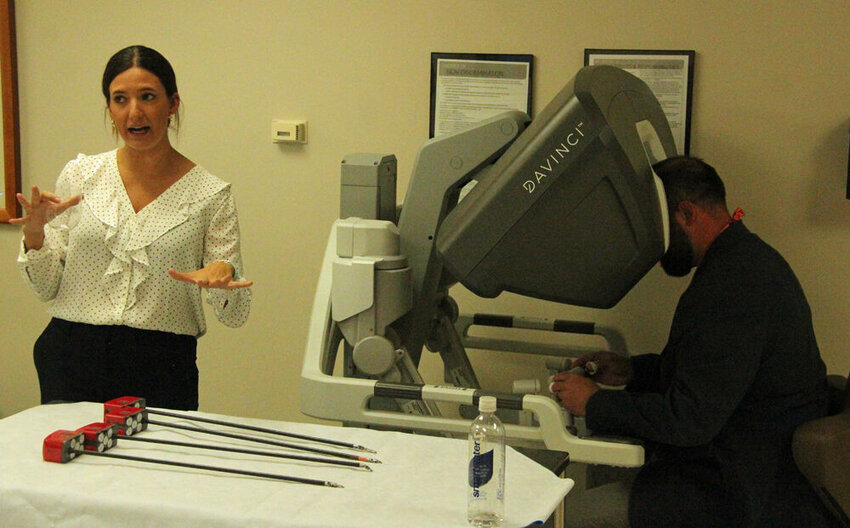 Dr. Steven Lyons (right) operates the da Vinci while Natalie Condon explains how the robot operates during the Business After Hours event at Northeast Regional Medical Center on June 6. Condon is an associate with Intuitive, the makers of the da Vinci, and helps install and grow robotics programs in hospitals.&nbsp;&nbsp;