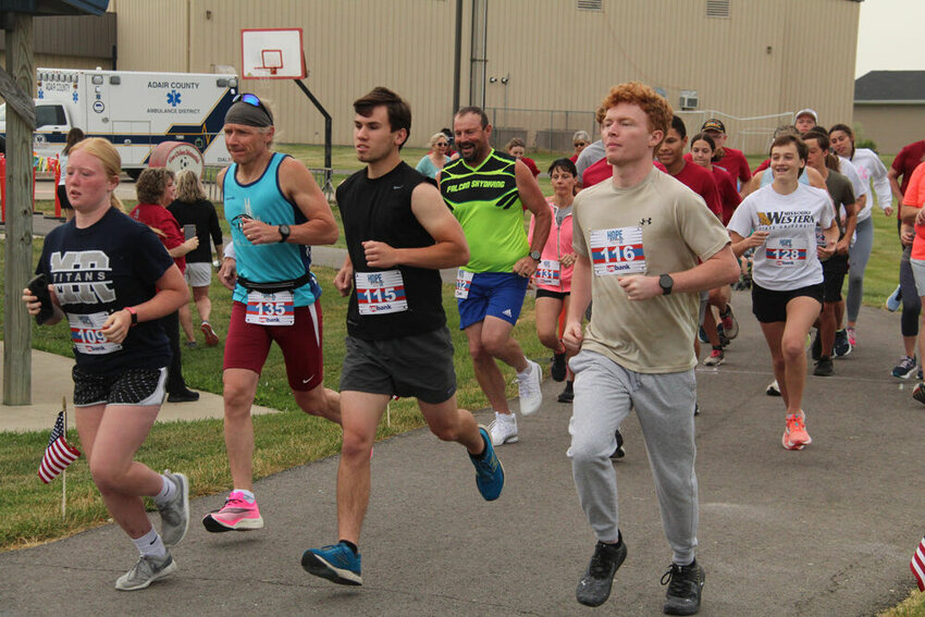 The participants in the Hope for Heroes 5K on June 10 take off from the starting line. The event was held at the Adair County Family YMCA.&nbsp;