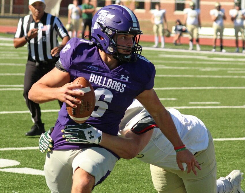 Truman State quarterback Nolan Hair looks to evade a defender in the Bulldogs' game against Missouri S&amp;amp;T on Oct. 8, 2022.&nbsp;