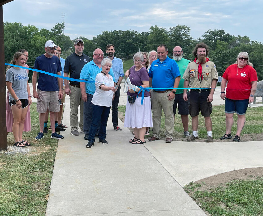 Elsie Gaber and Anne Moody cut the ribbon to officially open to the&nbsp;Kirksville Labyrinth Center. Jacob Thompson (in the scout uniform), built an adjoining gazebo at the site.&nbsp;