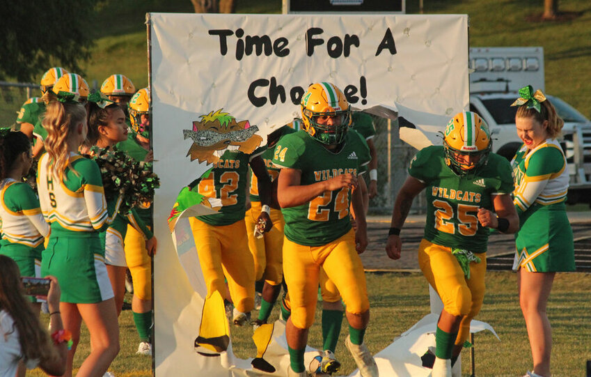 The Milan football team runs through the banner prior to the game against Putnam County on Sept. 8.&nbsp;