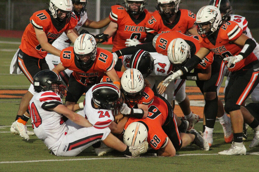 A large group of Kirksville defenders bring down Marshall running back Mason Evans (24) in the game on Sept. 22.&nbsp;