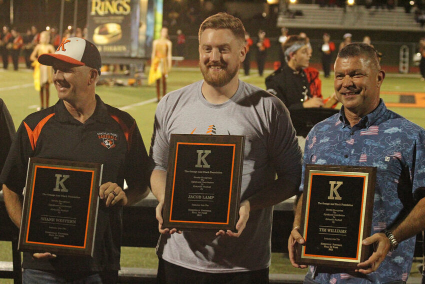 Shane Western, Jacob Lamp and Tim Williams pose after being presented with Kirksville Football Hall of Fame plaques at halftime of the game against Marshall on Sept. 22.&nbsp;
