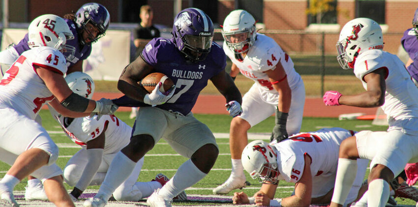 Truman running back Denim Cook runs through a sea of William Jewell defenders in the game on Oct. 21.&nbsp;