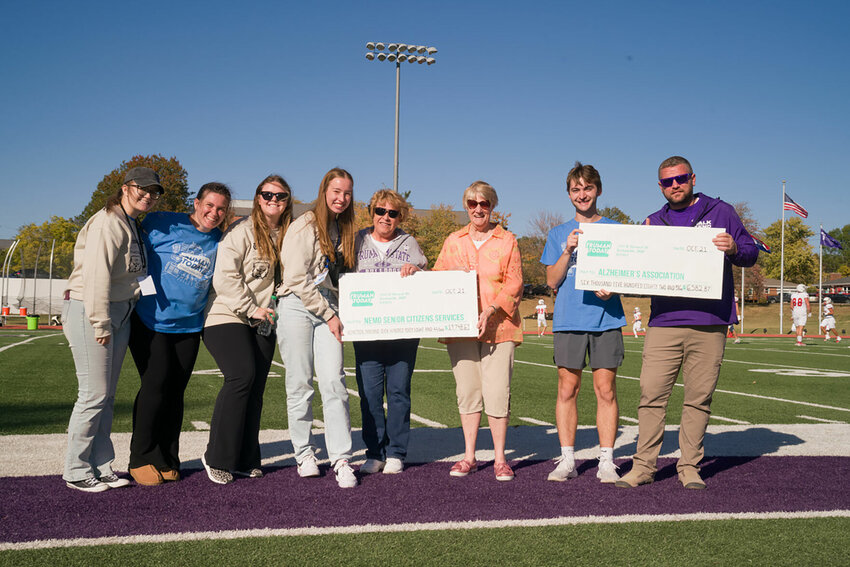Students from the Truman State University Homecoming Committee present checks to representatives from NEMO Senior Citizens Services and the Alzheimer&rsquo;s Association. All totaled, more than $24,000 was raised for charitable organizations during Homecoming festivities this year.