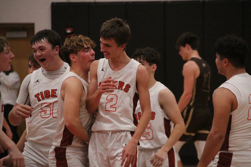 Kirksville senior Gavin Pike (2) celebrates with teammates after his third quarter dunk extended the Tigers lead in their win over Highland on Nov. 21.&nbsp;