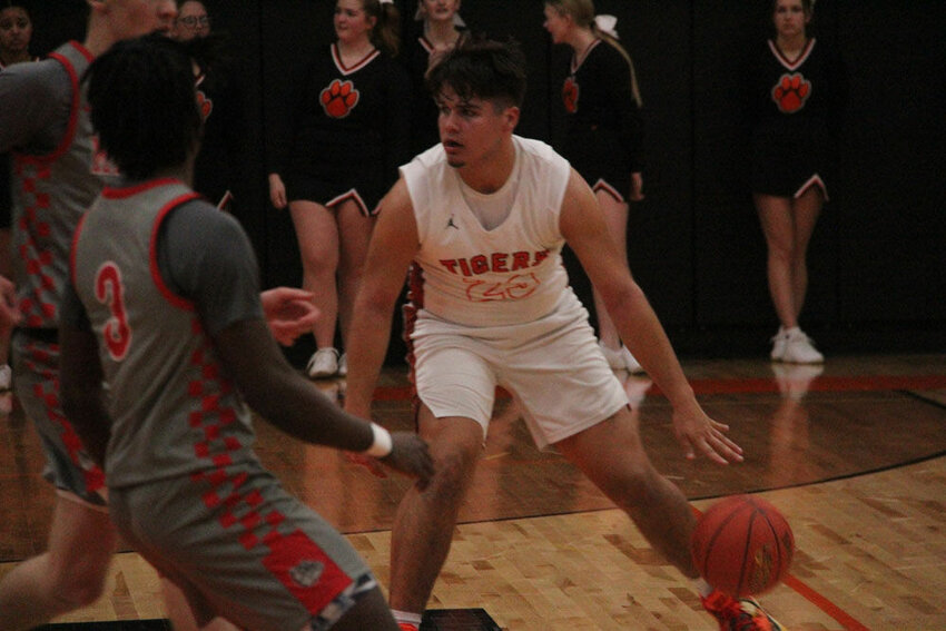 Kirksville junior Cole Kelly looks to dribble by a pair of defenders in the game against Mexico on Dec. 12.&nbsp;