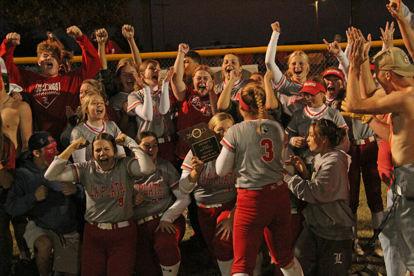 The La Plata softball team celebrates with fans after being presented with the district championship plaque on Oct. 17.&nbsp;