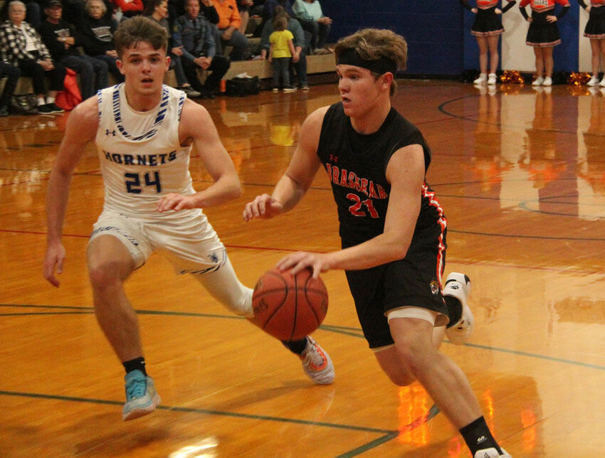 Brashear's Cole Erwin (right) looks to drive past Atlanta's JJ White in the game on Dec. 15, 2023.&nbsp;
