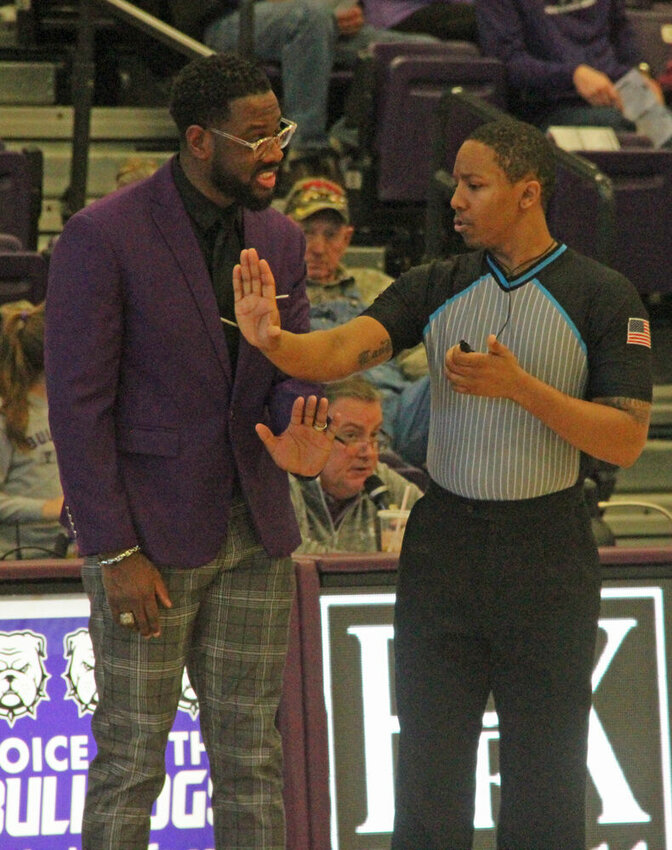 Truman head coach Theo Dean talks with an official during a timeout in the game against Drury on Jan. 20.&nbsp;