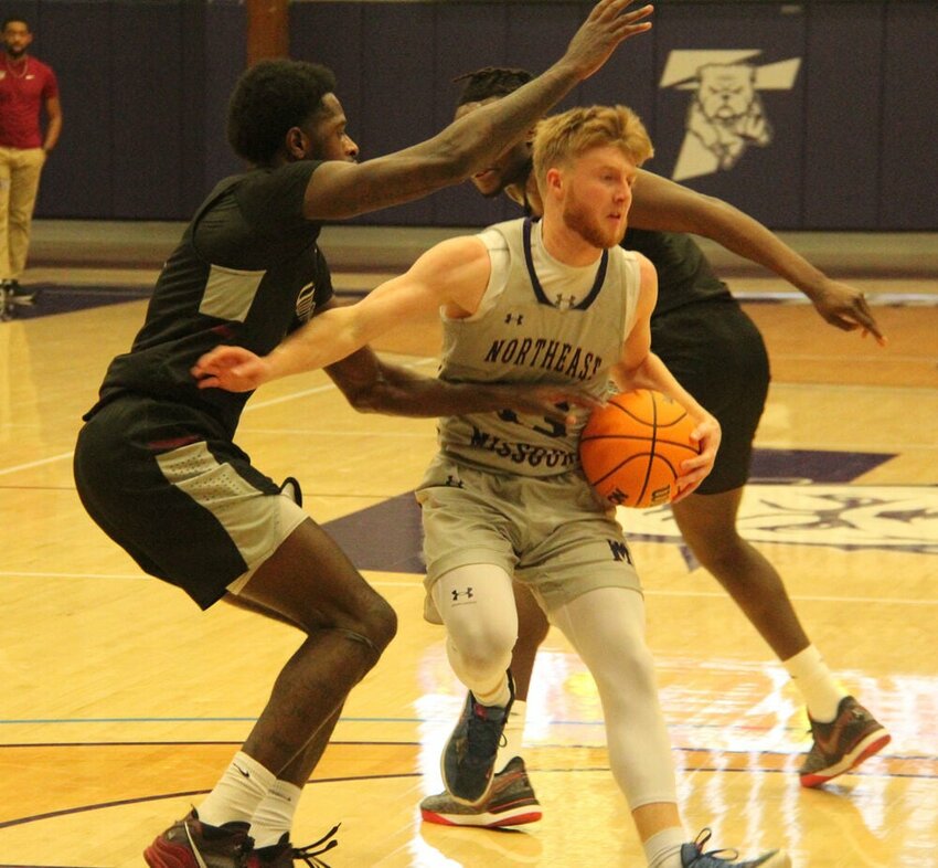 Truman guard Trey Shearer looks to escape a pair of defenders in the game against Indianapolis on Jan. 3.&nbsp;