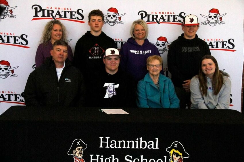 Hannibal senior Ryan Ross, second from right in front row, surrounded by his family after signing his national letter-of-intent with Truman State University on Wednesday at Korf Gymnasium.