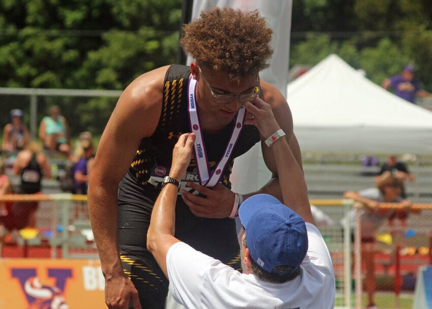 Green City senior Asher Buggs-Tipton is awarded his second-place medal for the 100 meter dash final at the MSHSAA Class 1-3 State Track and Field Championships on May 18.&nbsp;