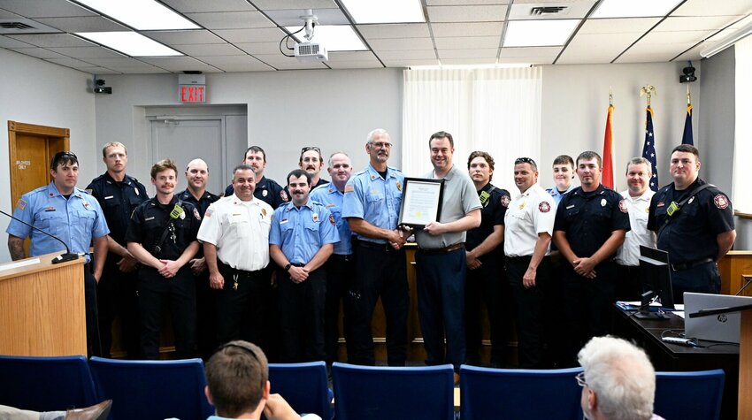 City officials honor Fire Capt. Ken Scott at a city council meeting.&nbsp;