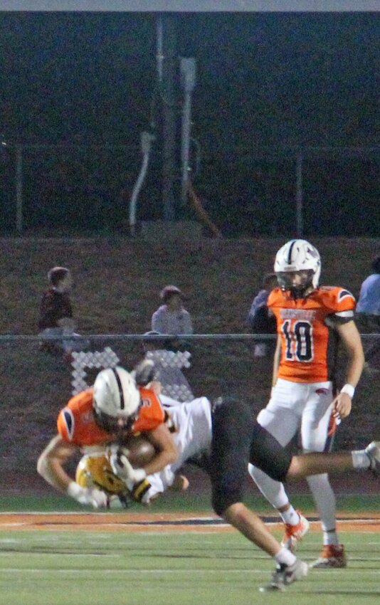 Junior running back Logan Martin grinds to get past the first down marker as senior quarterback Ryder Lyons looks on. Kirksville handled a not very good Fulton team, 42-0, to claim the conference championship outright.