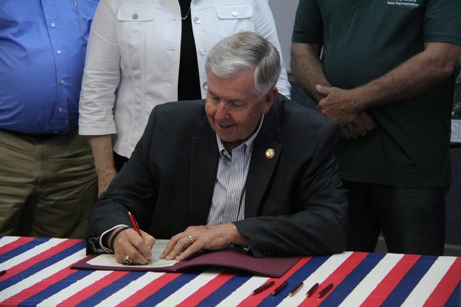 Missouri Gov. Mike Parson signs SCR 7, a resolution that will contribute up to $24 million toward the East Locust Creek Reservoir project, in Milan on Thursday.