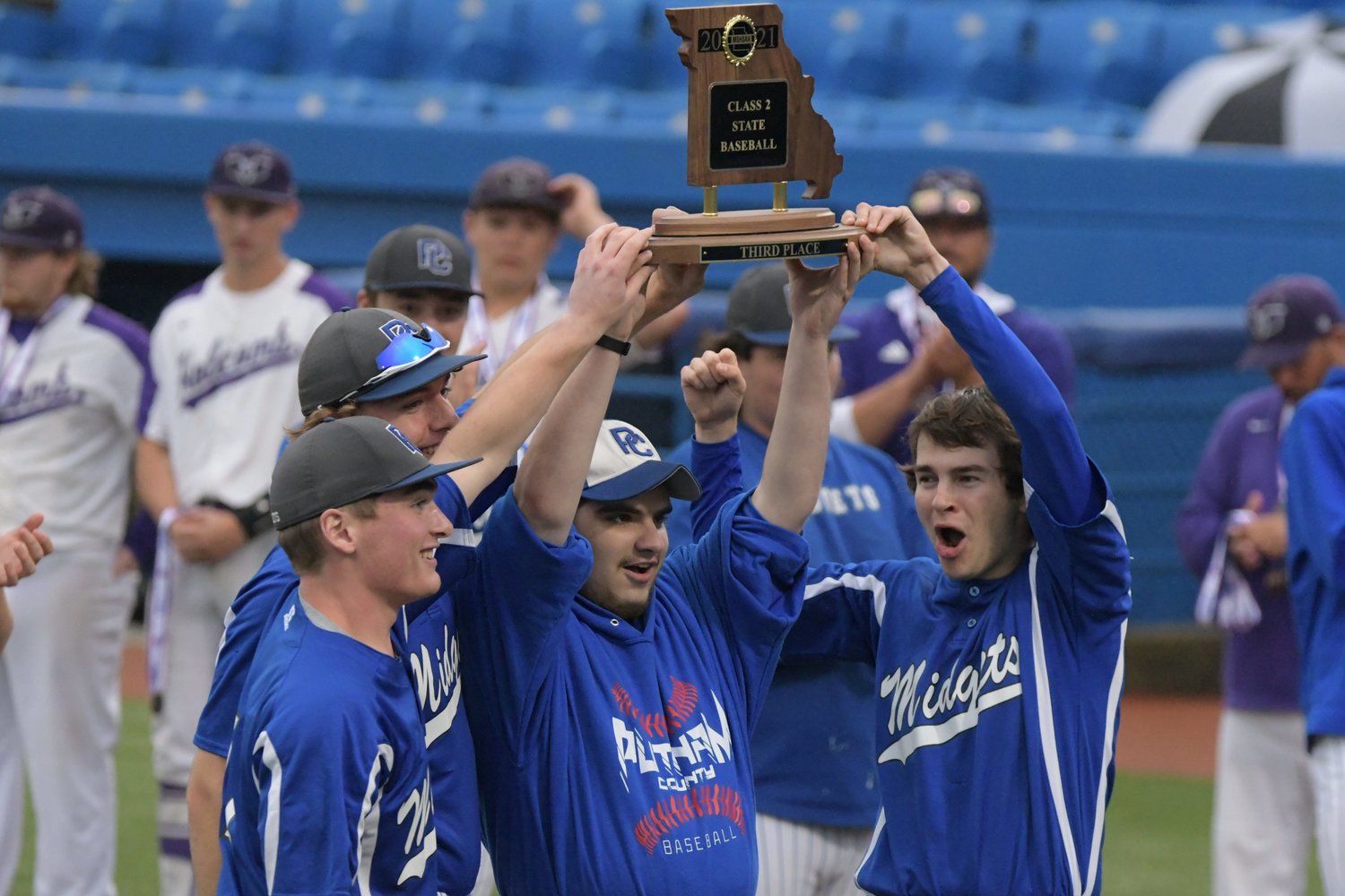 Members of the Putnam County baseball team hoist their third-place trophy after defeating Holcomb.
