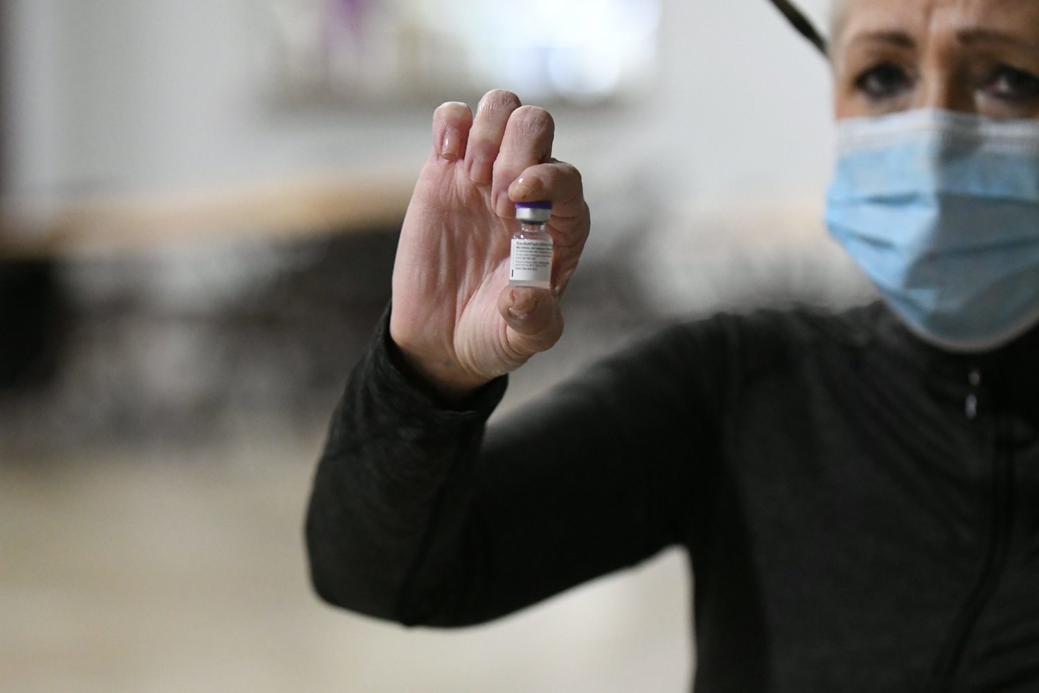 Lori Guffey, clinic supervisor and communicable disease specialist at the Adair County Health Department, holds up a vial of the Pfizer COVID-19 vaccine.