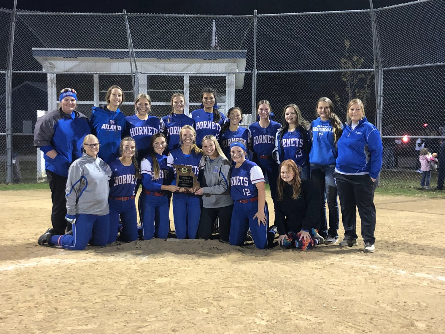 The Atlanta softball team poses with its district trophy after beating Linn County on Friday night
