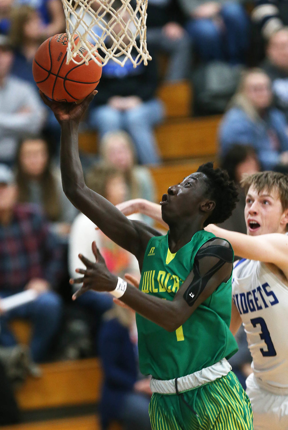 Basketball action between Putnam County Lance Fowler, right,  and Milan's Chekh Niasse Friday evening at Putnam County High School...