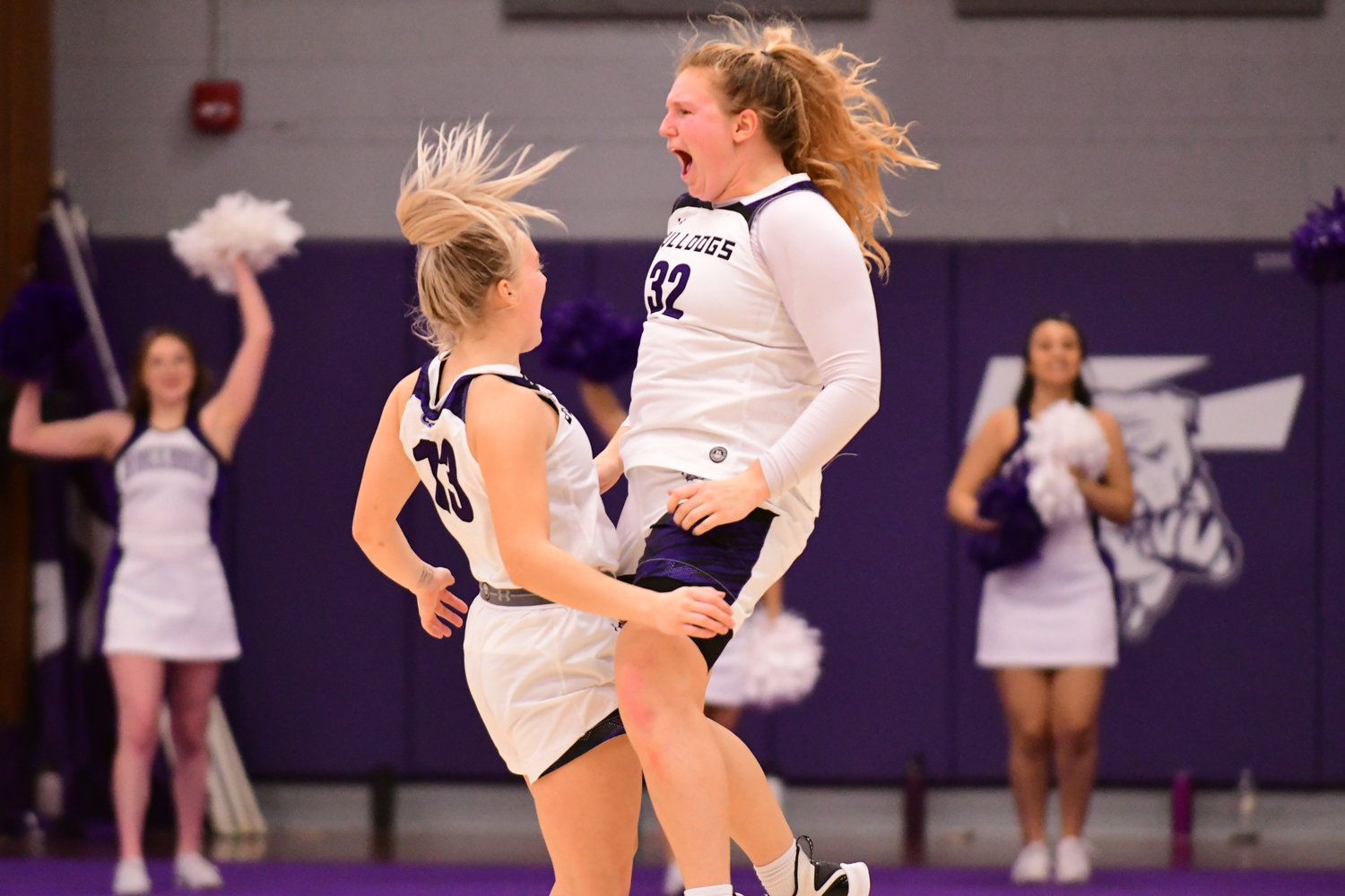 Truman's Ellie Weltha and Hannah Belanger celebrate after a 67-66 win over Drury, the first in Bulldog history.