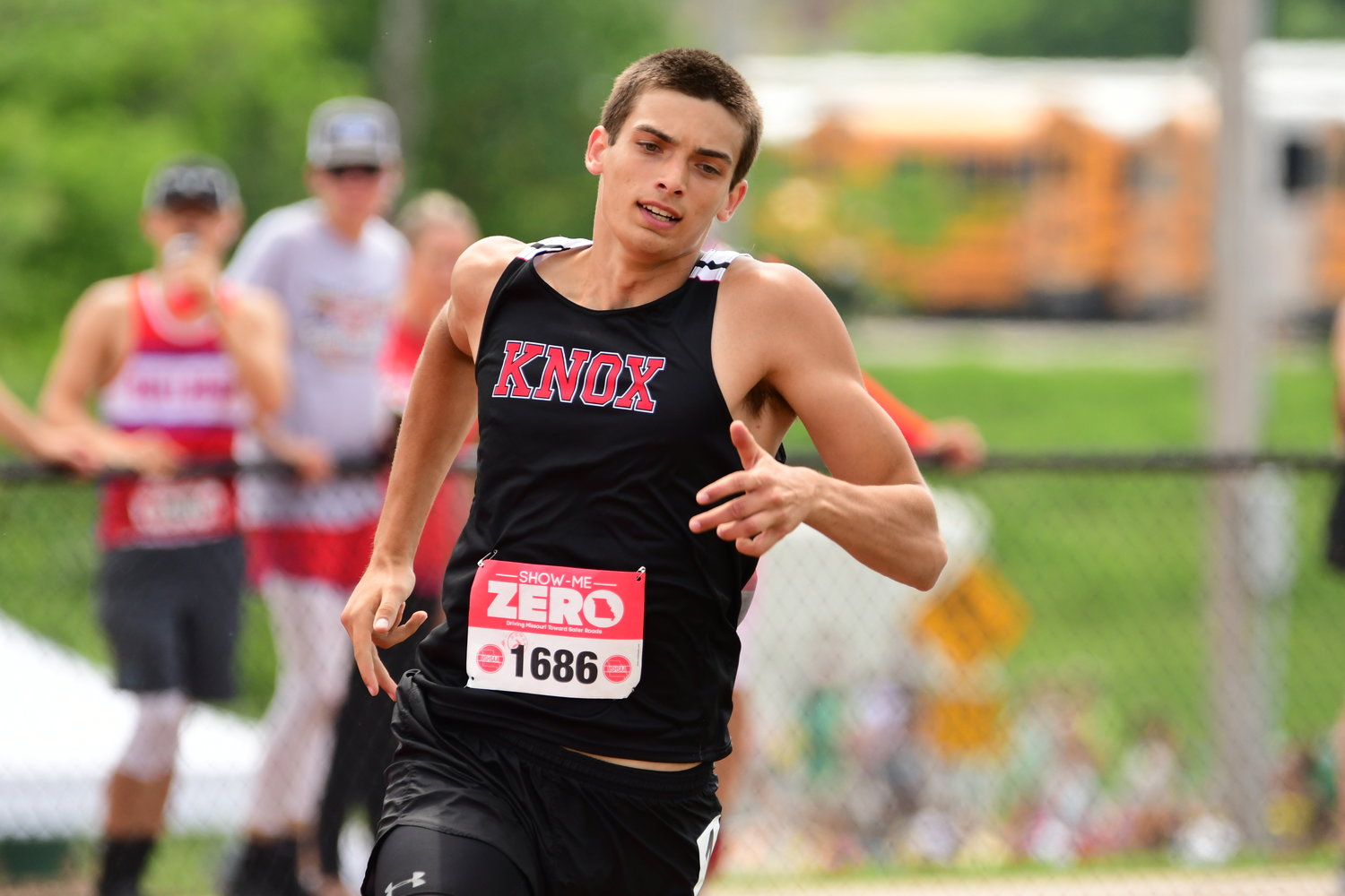 Knox County's Jacob Becker competes in a Class 1 boys 400m prelim race.