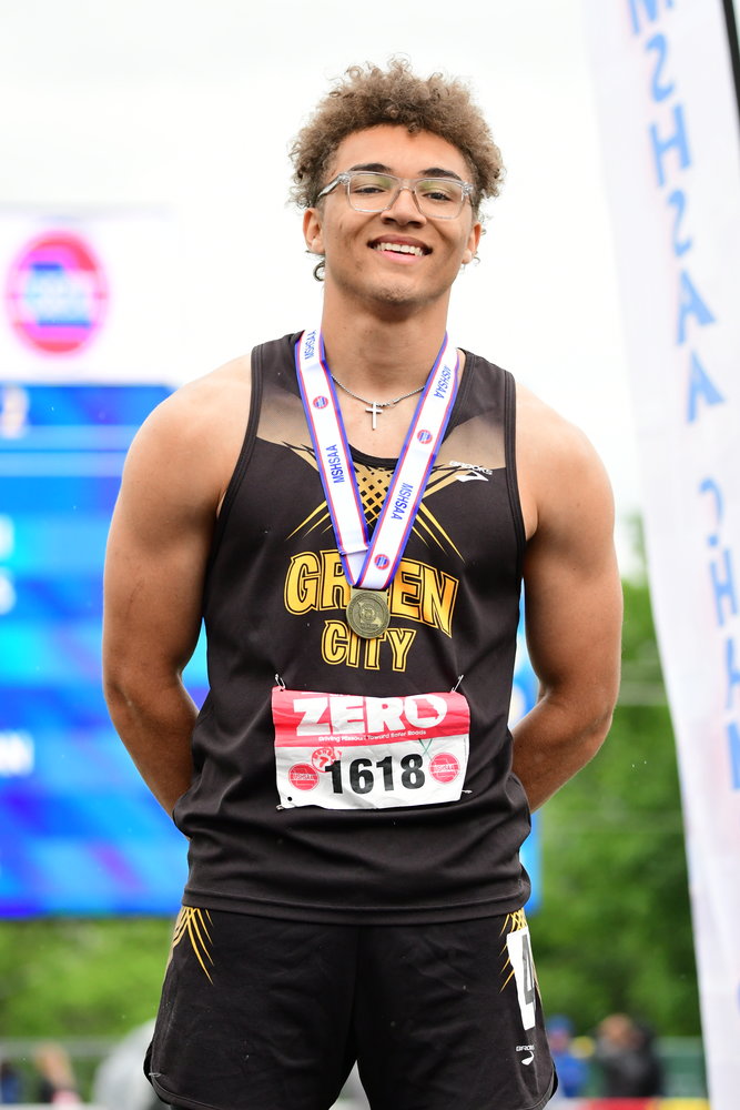 Green City's Asher Buggs-Tipton stands atop the podium after winning the Class 1 boys triple jump at the 2022 MSHSAA State Track Championships.