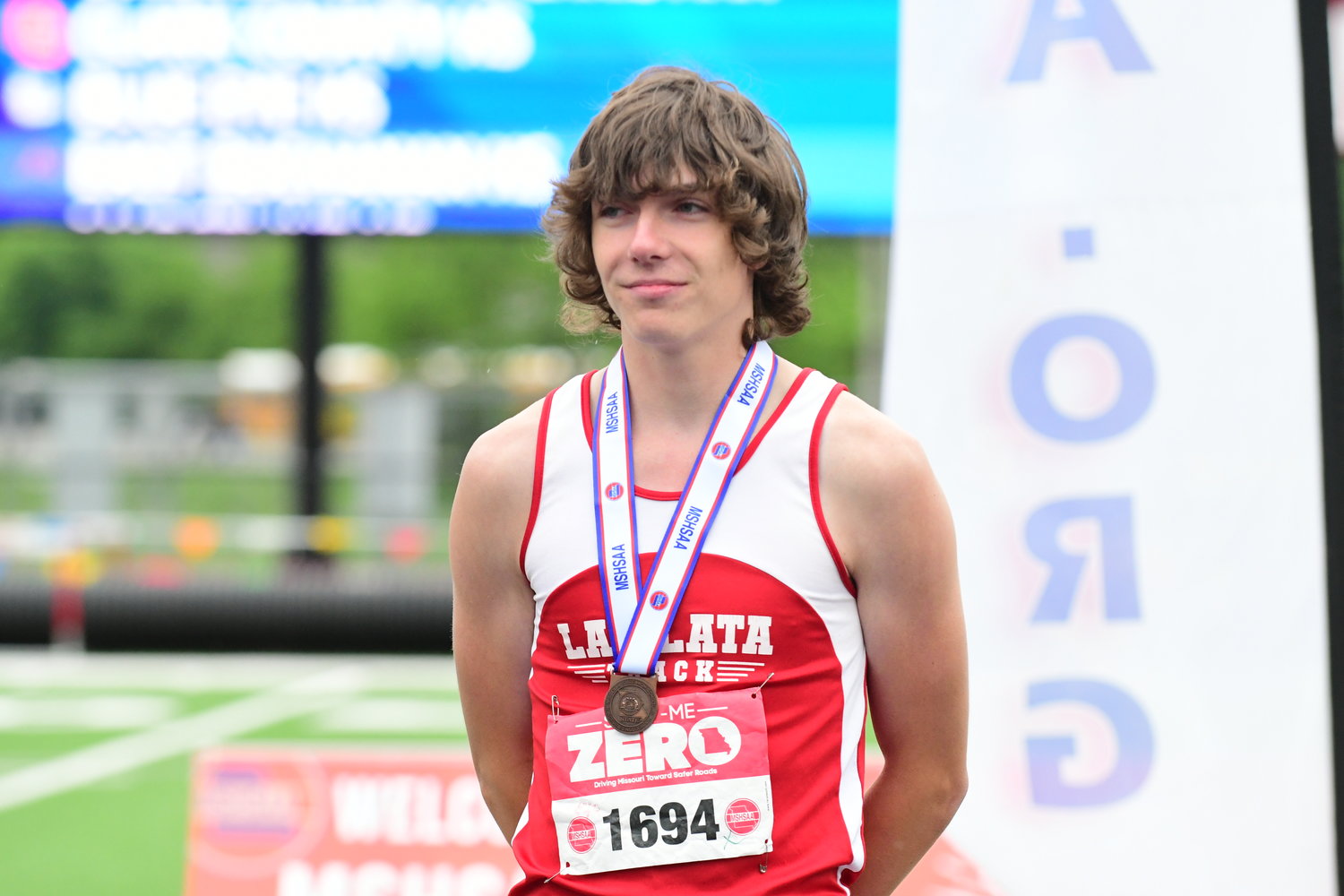 La Plata's Neil Green poses on the podium after taking sixth in the Class 1 boys pole vault.