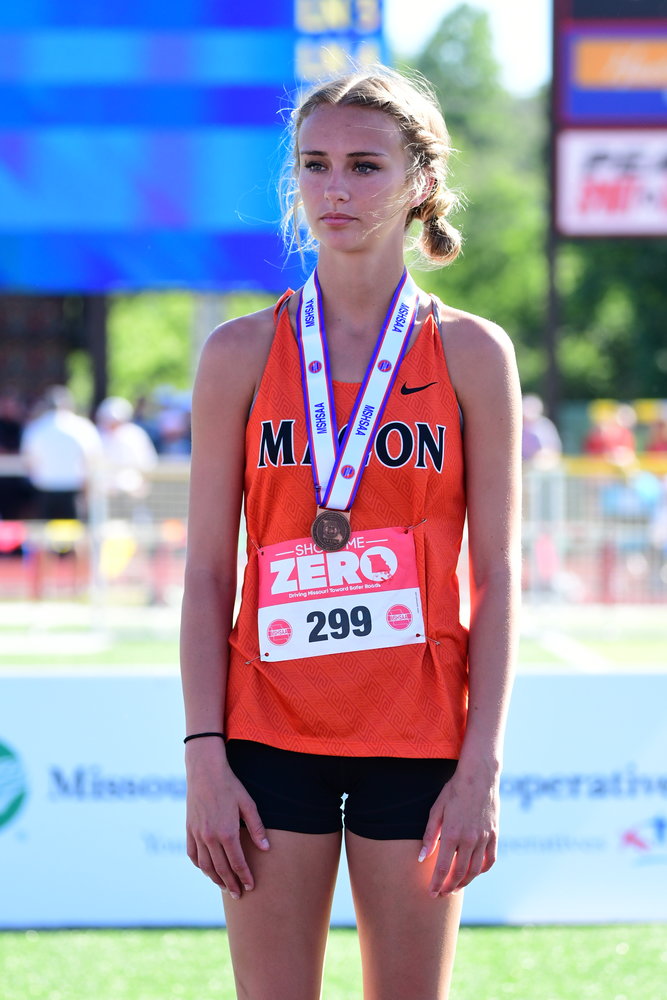 Macon's Shelby Petre stands on the podium after taking fourth in the Class 3 girls high jump.