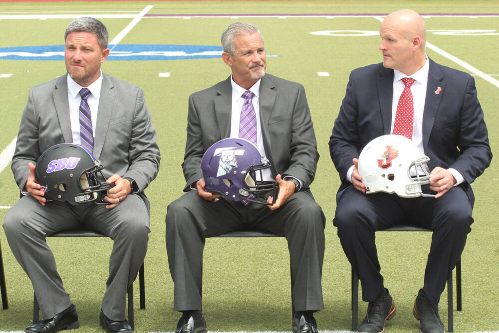 Truman State head coach Gregg Nesbitt (center) sits for a photo alongside fellow coaches Robert Clardy of Southwest Baptist (left) and William Jewell's Mike McGlinchey during the GLVC Football Kickoff event held July 29 at McKendree University. 