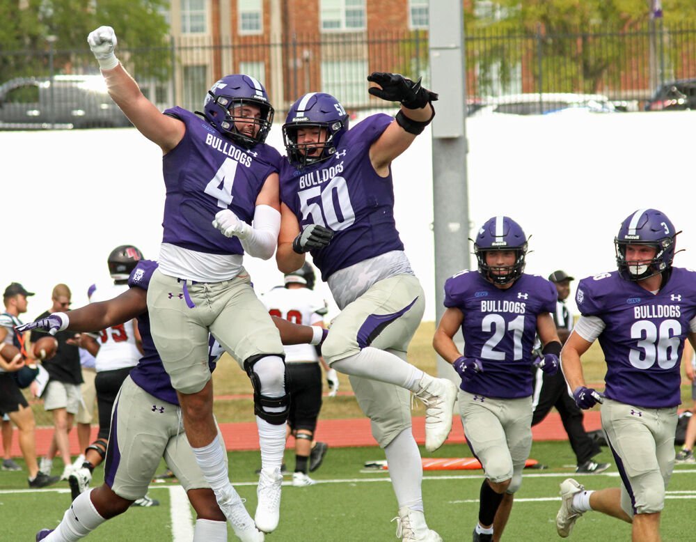 Truman State defensive linemen Alec Devecchi (4) and Jack Marth (50) celebrate after Marth forced a safety in the game against Davenport on Sept. 3. 