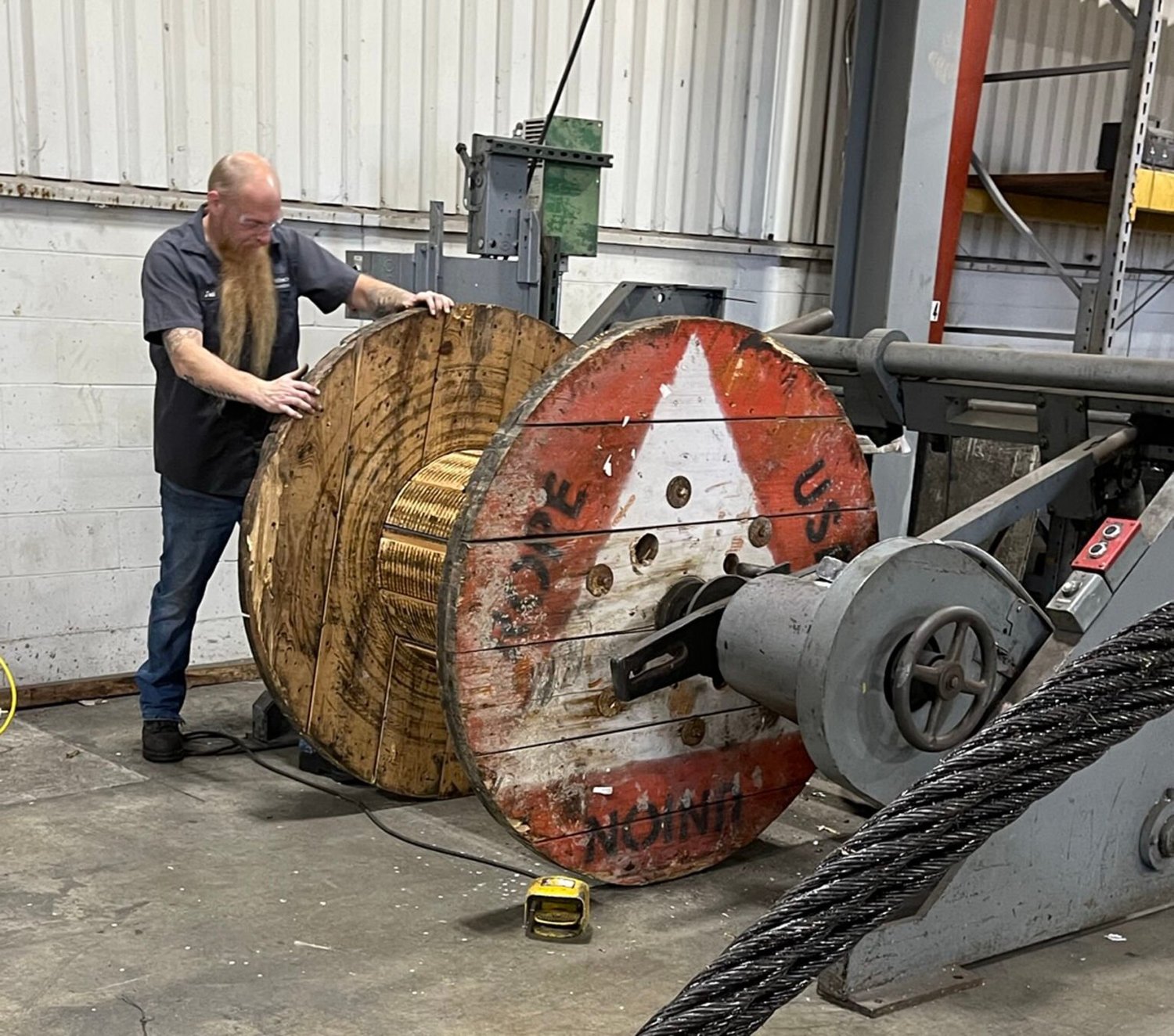 Worker setting up reel to package final wire rope assembly