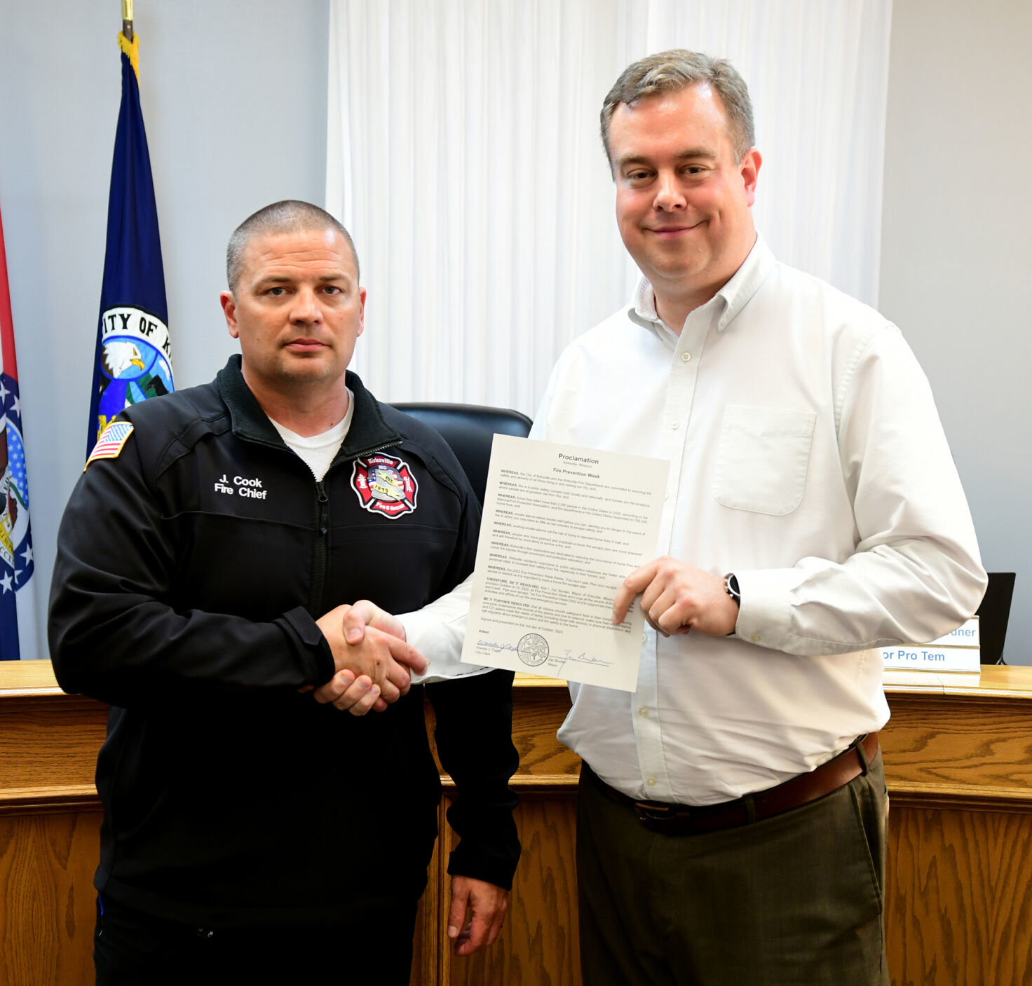 Kirksville Fire Chief Jon Cook (left) receives a proclamation from Mayor Zac Burden.