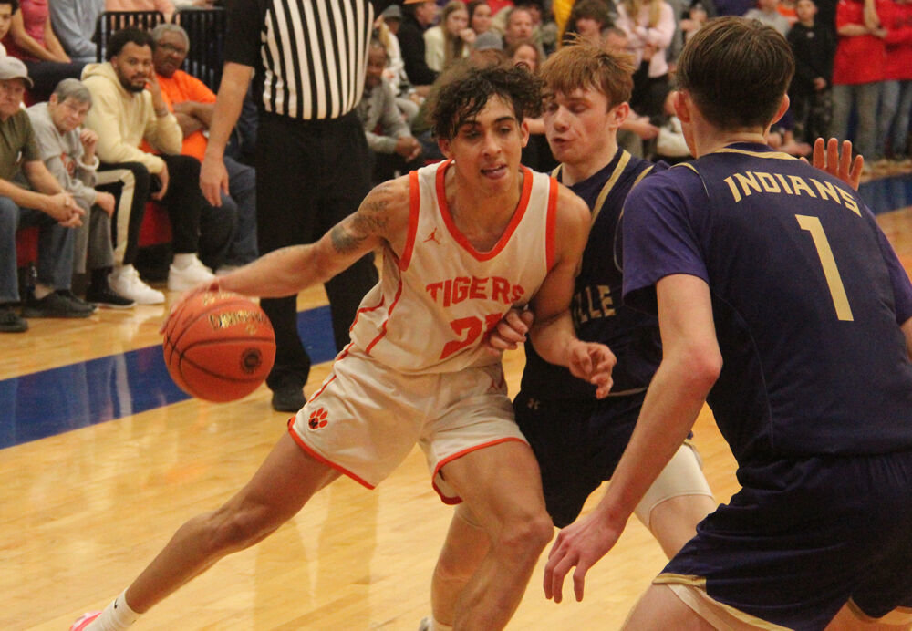 Macon senior Boston Douglas battles with a Hallsville defender in the game on March 1. 