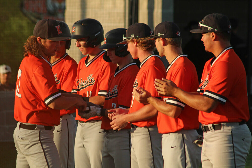 Kirksville's Tanner Ferguson gives teammates high fives as lineups were introduced prior to the game against Macon on May 16. 
