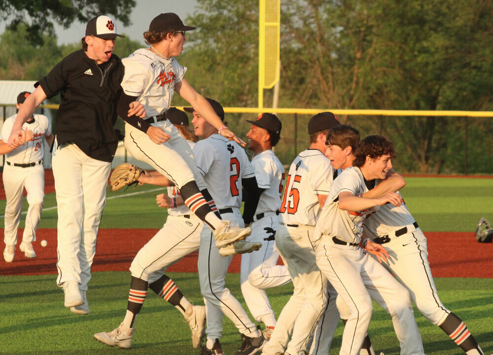 The Macon baseball team storms the field to celebrate after the final out of their win over Mexico on May 18. 