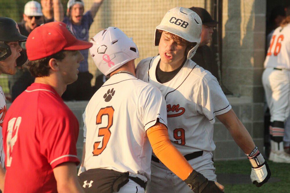 Macon players Trey Hatcher (3) and Logan Petre (9) celebrate after scoring the tying and go-ahead runs in the game against Mexico on May 18. 