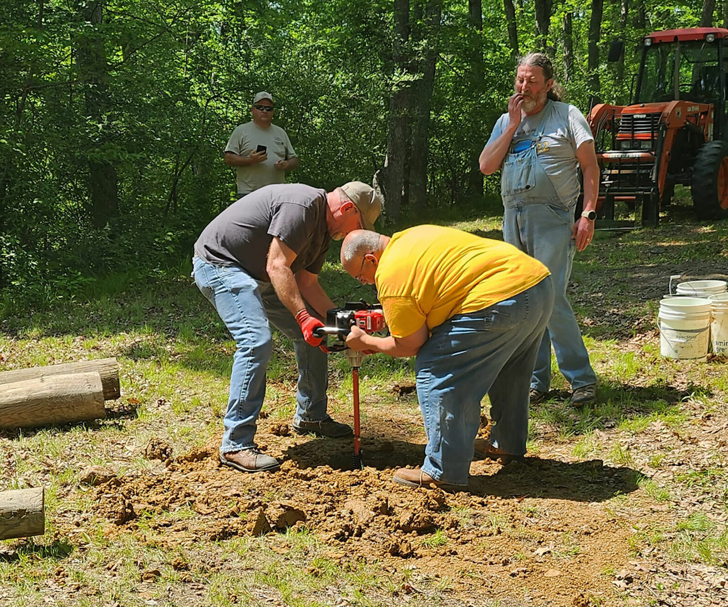 Wally Ward (left) and Patrick Nolan battle through clay with a gas auger.