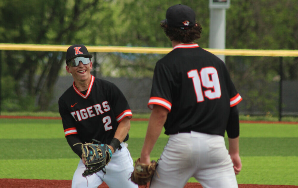 Kirksville senior Jalen Kent smiles at fellow senior Keaton Anderson after catching a popup to end the Tigers' win over Centralia in the district tournament on May 13. 