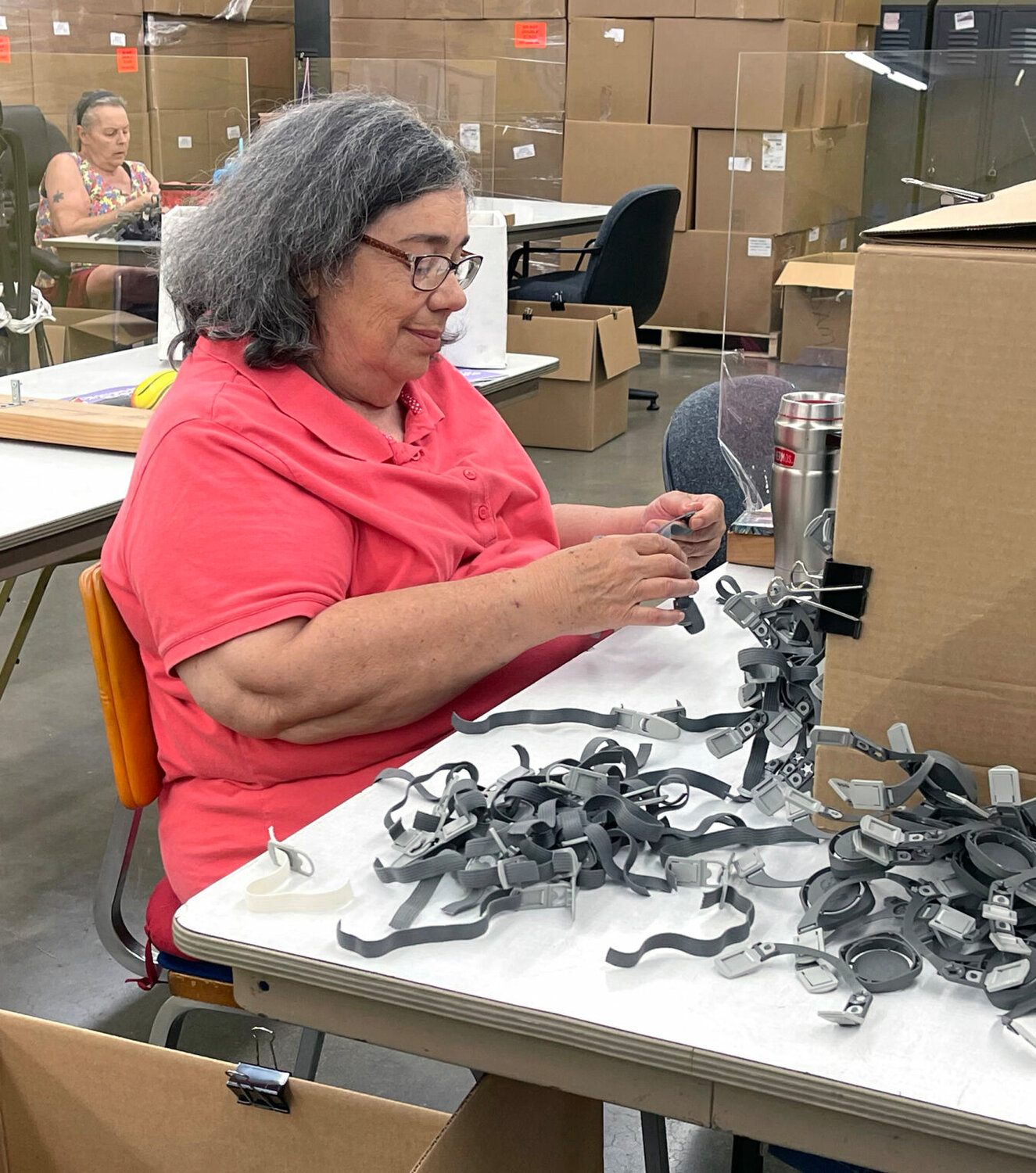 A worker at Community Opportunities puts together straps that will be shipped to a plant in Columbia that will use them on masks they assemble. 