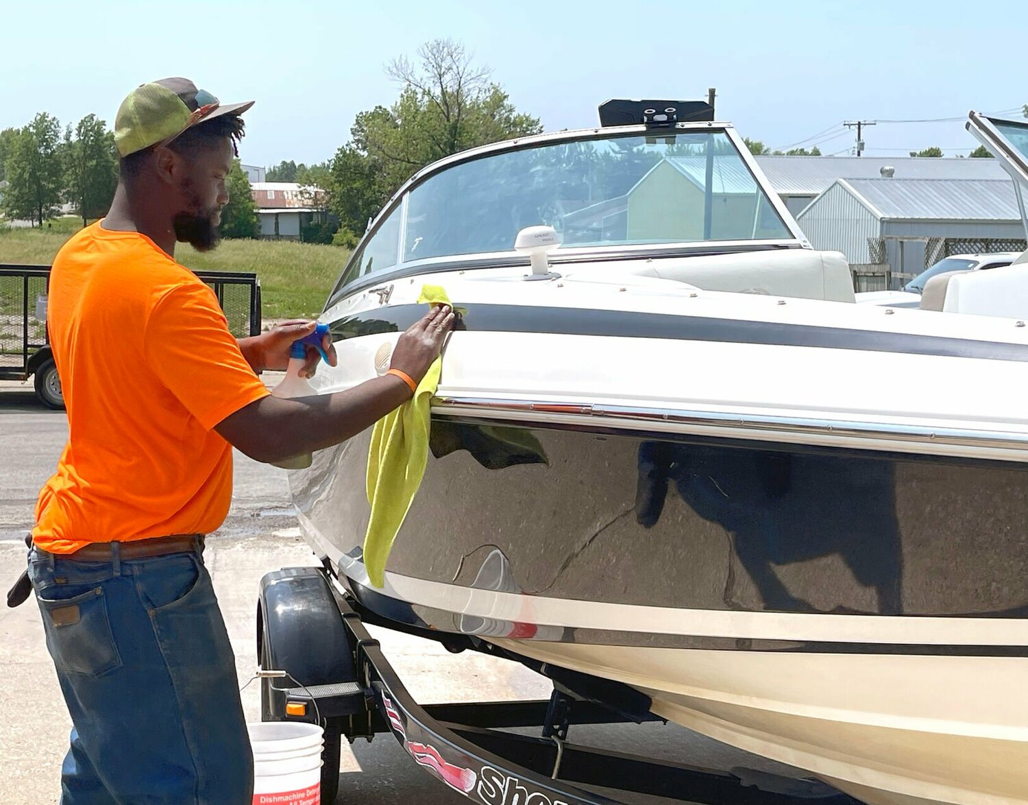 A worker at Community Opportunities details a boat. The company details cars, boats, etc. by appointment. 