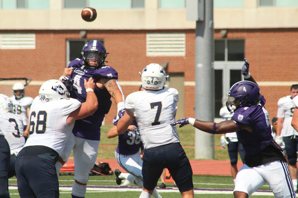 South Dakota Mines quarterback Jayden Johannsen throws the ball while under pressure from Truman's Ulysses Ross (4) and Ben Miller (44) during the game on Sept. 9. 