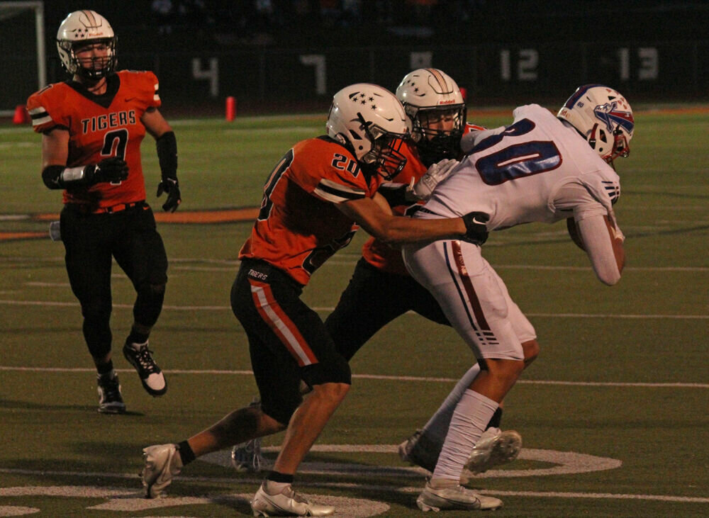 Kirksville defenders Jake Bohon (20) and Carter Pinkerton (11) work to bring down a Moberly ballcarrier in the game on Sept. 15. 