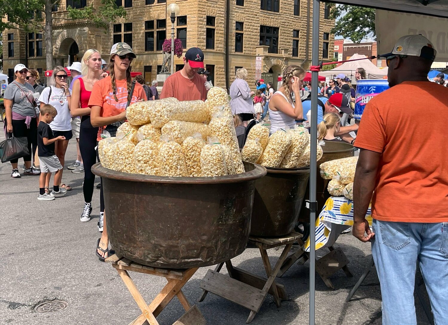 People line up to buy fresh made popcorn at the Red Barn Arts and Crafts Festival.