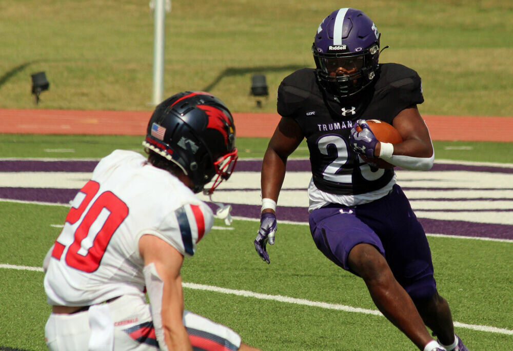 Truman State running back Tim Johnson Jr. looks to run by a Saginaw Valley State defender in the game on Sept. 16. 