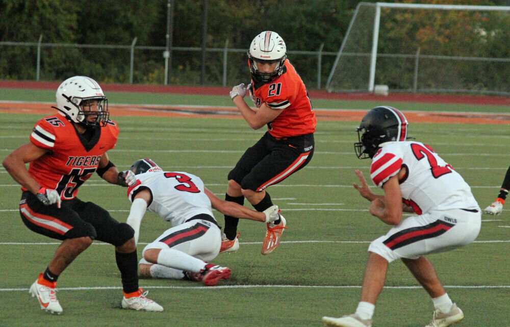 Kirksville running back Jace Kent (21) looks to slip out of a tackle and get a block from Tony Tiberi-Ramos (15) in the game against Marshall on Sept. 22. 