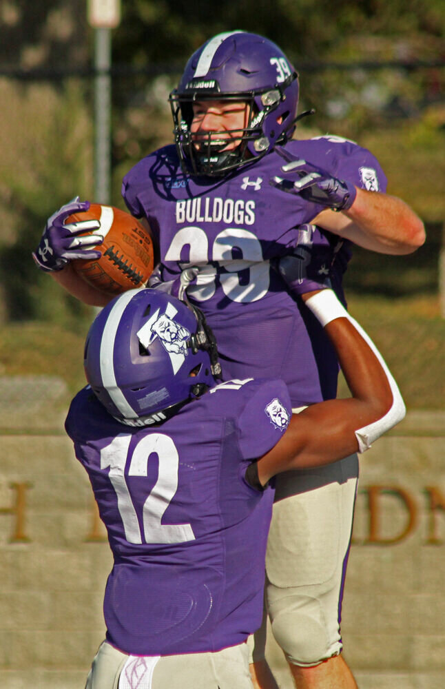 Truman running back Mason Huskey (39) is lifted by Joseph Spaulding as they celebrate Huskey's touchdown against William Jewell on Oct. 21. 